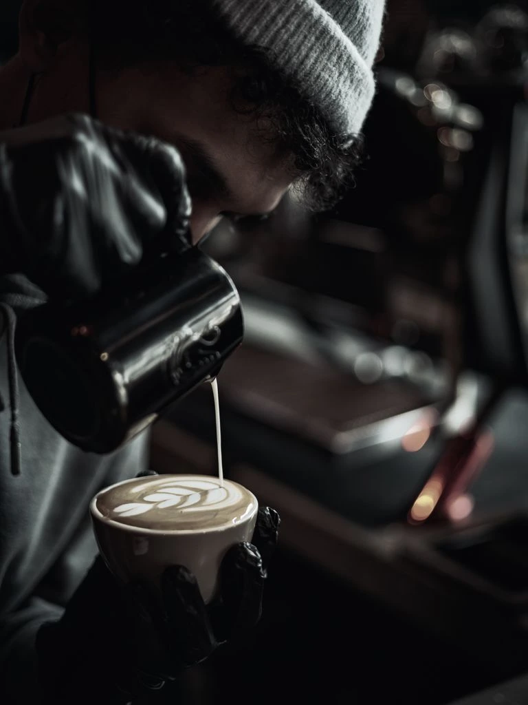 A barista pours a slow pour-over at the Lava Café flagship.